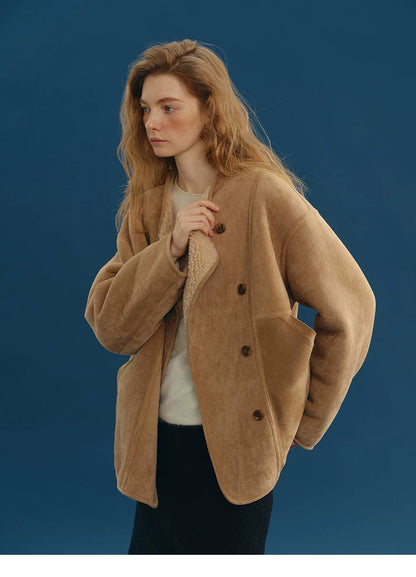 Camel faux-suede jacket buttoned with the cream wool edge peeking at the neckline