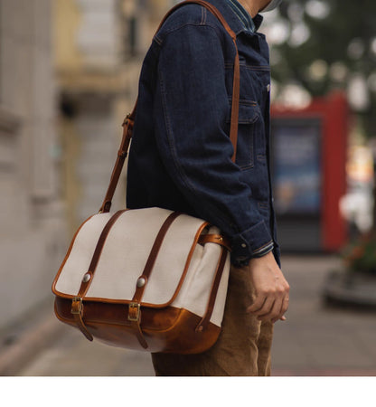 Man wearing beige canvas and leather messenger bag crossbody in the street