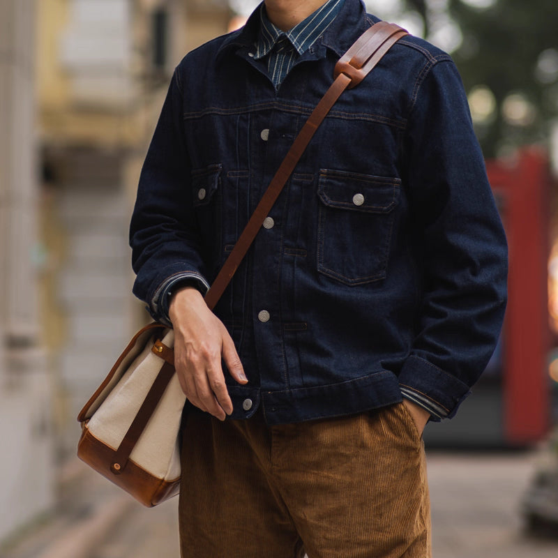 Side view of messenger bag worn on shoulder showing bag depth and leather strap