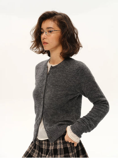 Woman in charcoal gray alpaca cardigan and plaid skirt, side profile portrait