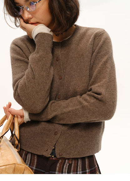 Woman holding bag while wearing coffee brown yak-cashmere cardigan