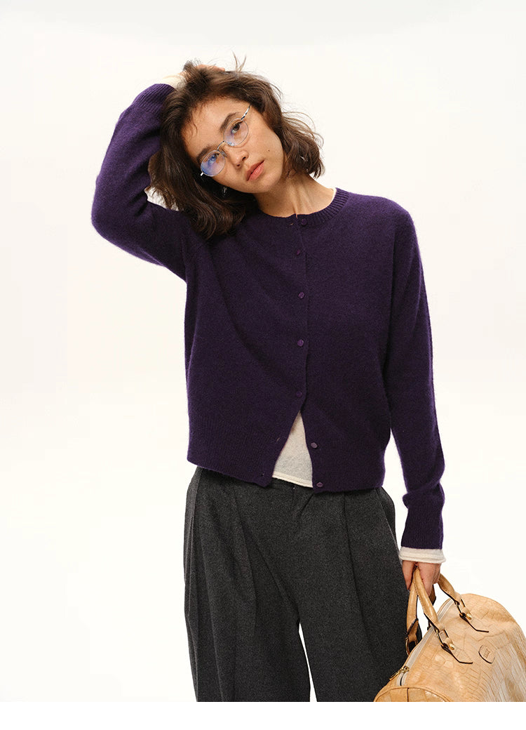 Woman wearing deep purple yak-cashmere cardigan, front view, relaxed fit