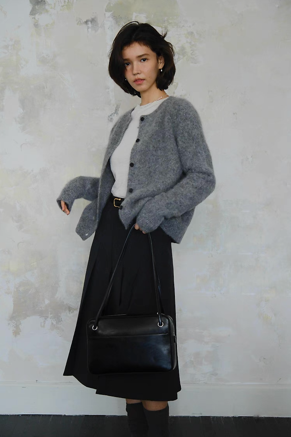 Grey button-up cardigan with white tee and black skirt, elegant women’s outfit