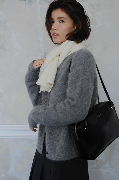 Grey fuzzy cardigan paired with white scarf and black shoulder bag, stylish winter wear