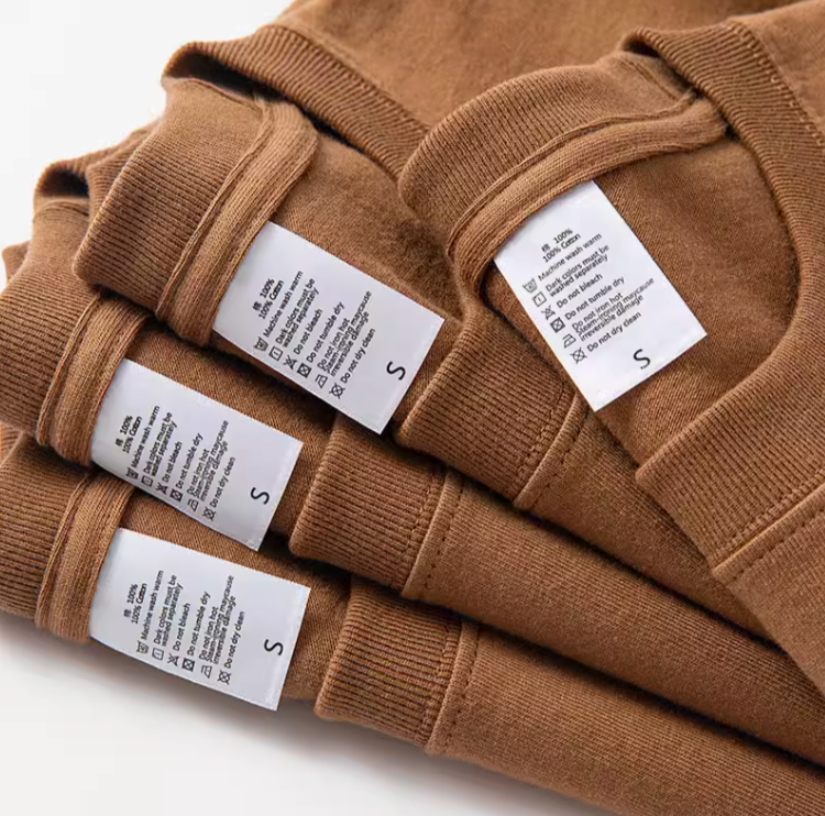 Casual Caramel Tee Dark Caramel cotton T-shirt stacked with care label detail close-up