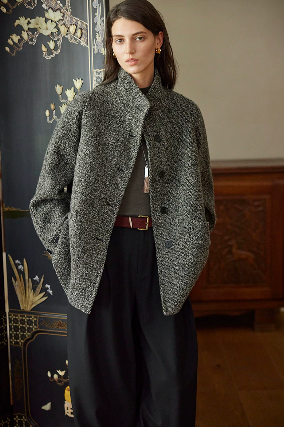 Charcoal flecked wool tweed jacket worn unbelted and open, showing the straight hip-length cut
