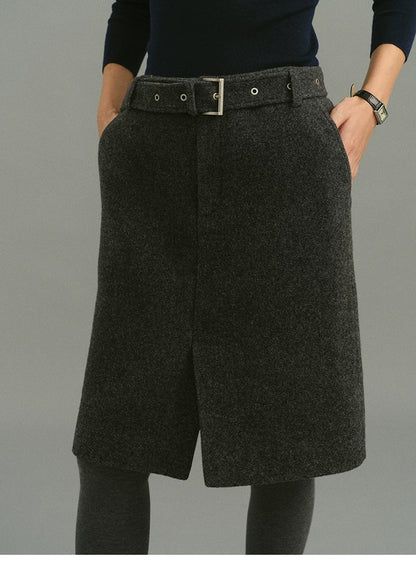 Front view of Charcoal Gray belted wool skirt with metal buckle and front hem slit