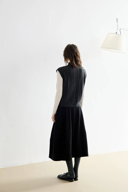 Back view of Charcoal Gray wool vest showing allover cable pattern and ribbed hem