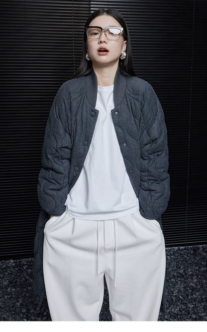 Charcoal quilted wool-blend down coat worn open, showing the ribbed stand collar and snap front