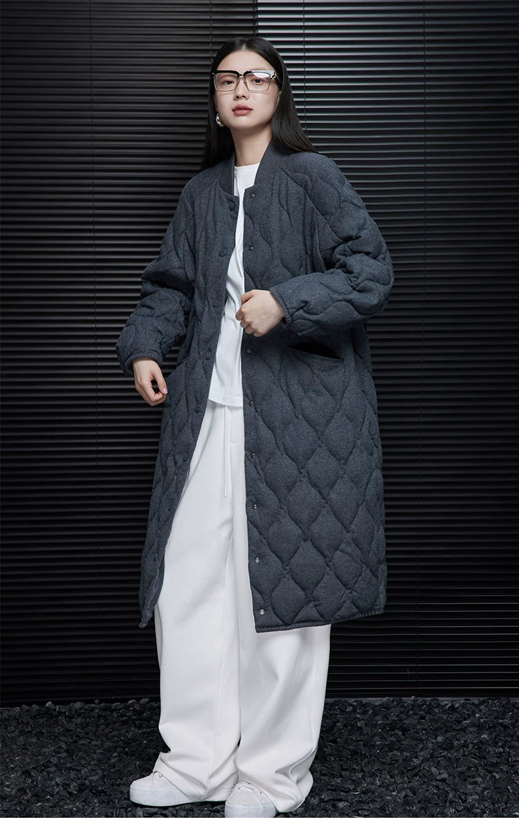 Full-length front view of a Charcoal longline down coat with diamond quilting and side pocket