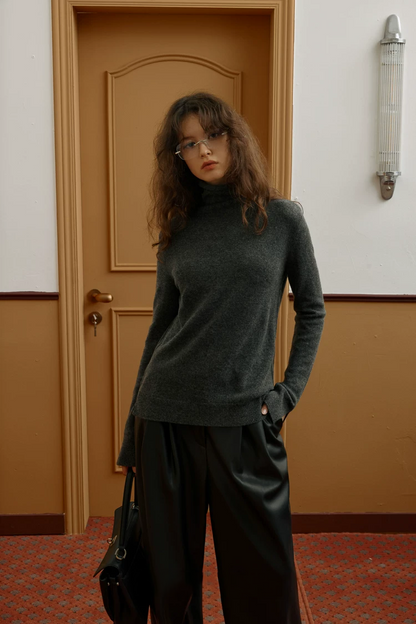 Front view of a Charcoal slim cashmere turtleneck worn untucked at hip length