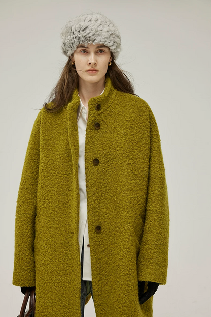 Chartreuse wool bouclé cocoon coat buttoned up, with slanted side pockets and wide sleeves