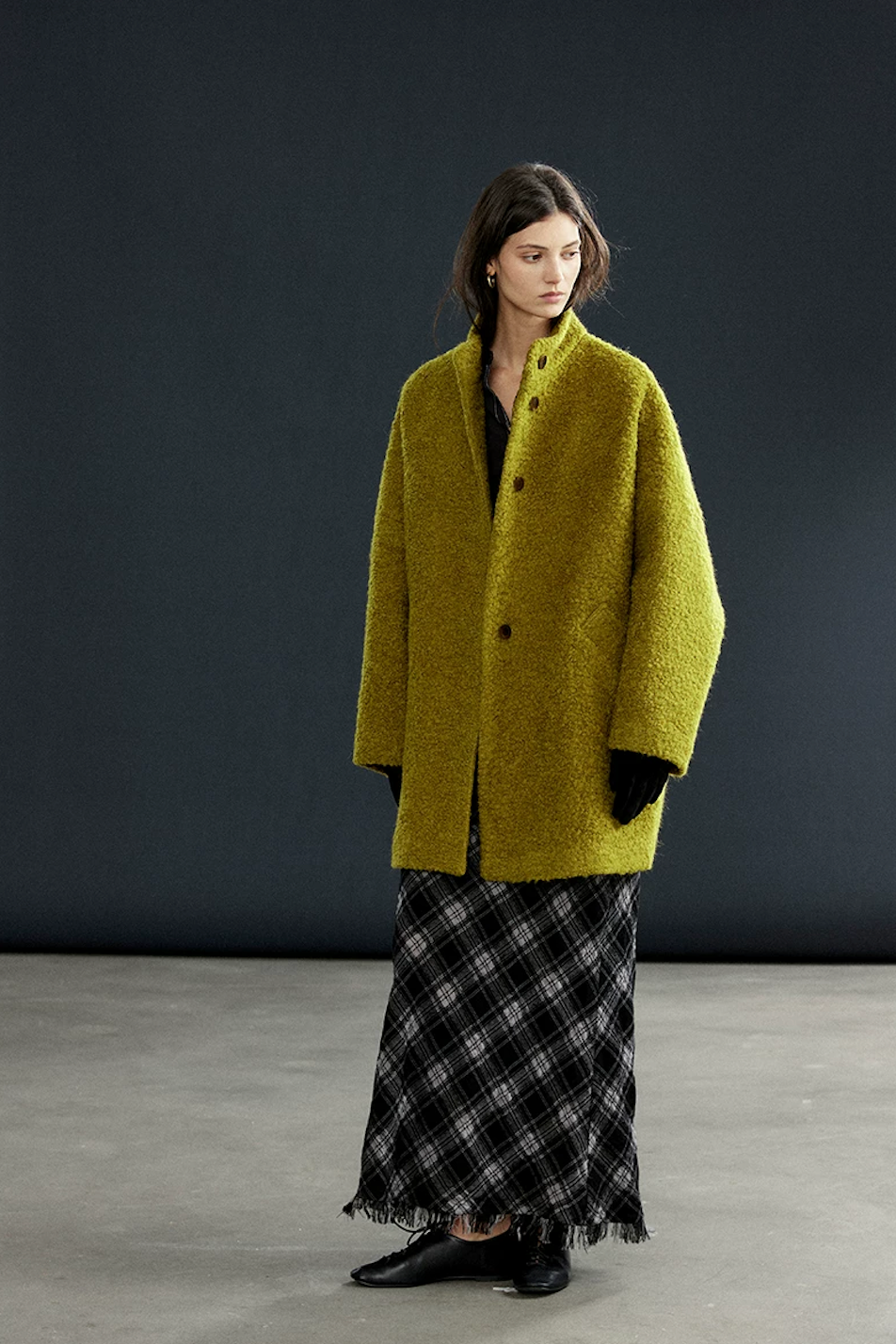 Full-length view of a Chartreuse bouclé wool coat with stand collar and straight H-line cut
