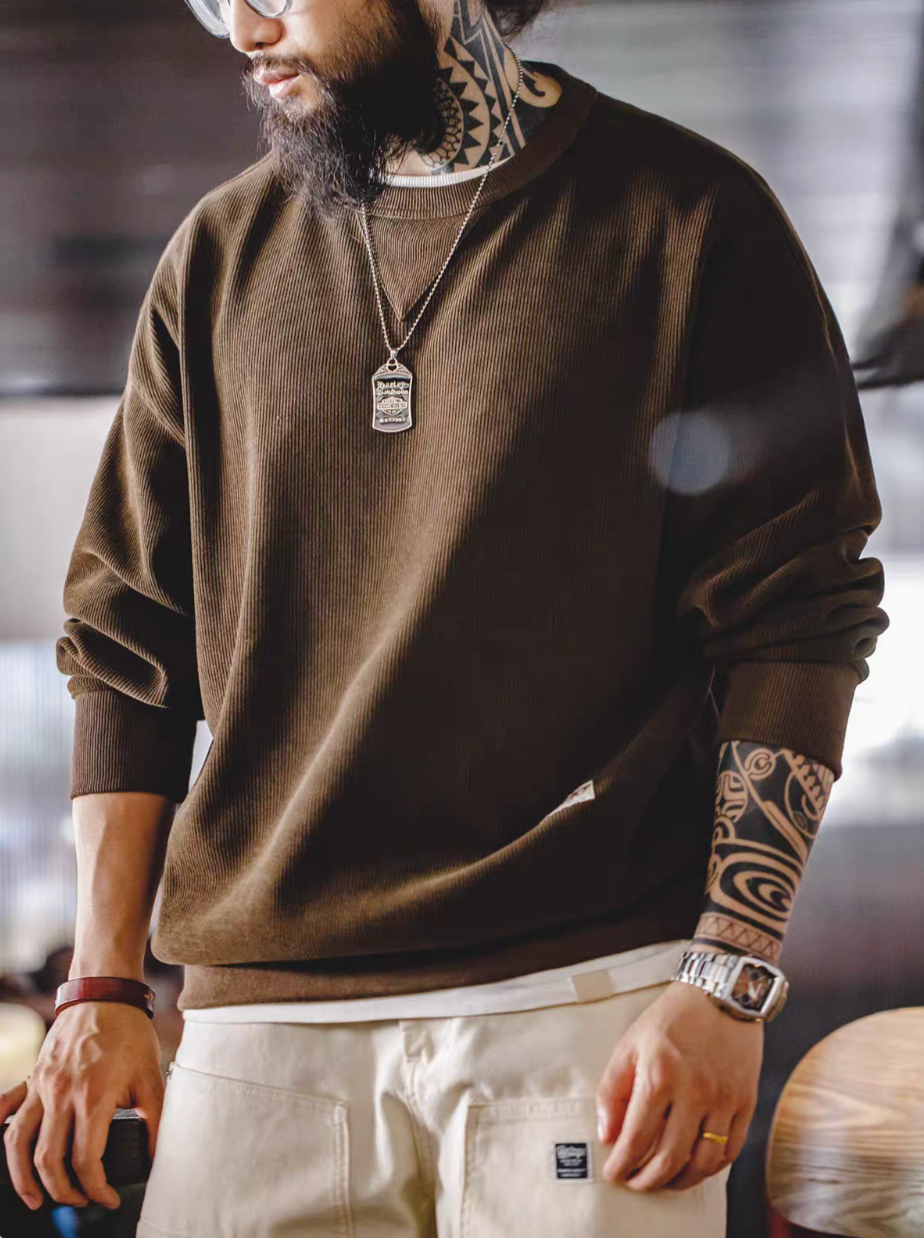 Coffee chenille crew sweater with triangle neck patch worn by model front view paired with light pants casual outfit