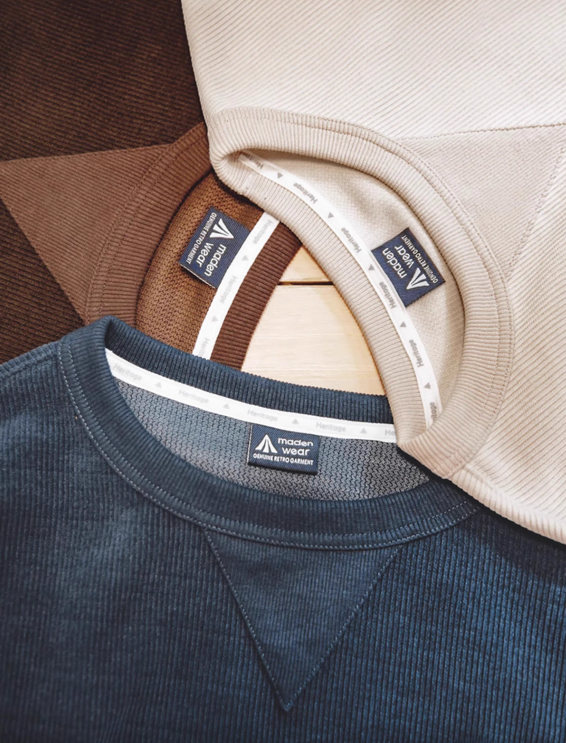 Chenille crew sweater with signature triangle neck patch showing Ivory, Coffee, and Navy color options close-up collar detail