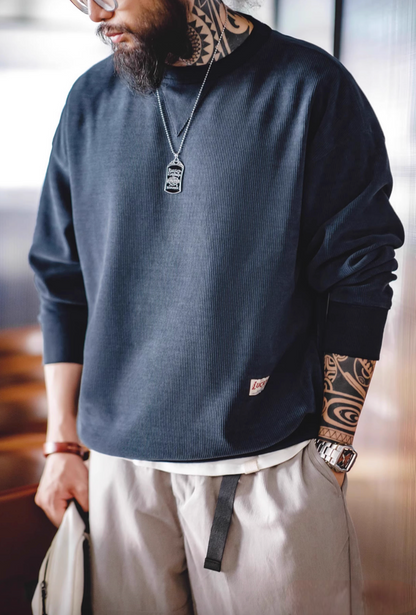 Navy chenille crew sweater with signature triangle neck patch front view worn by model with neutral pants
