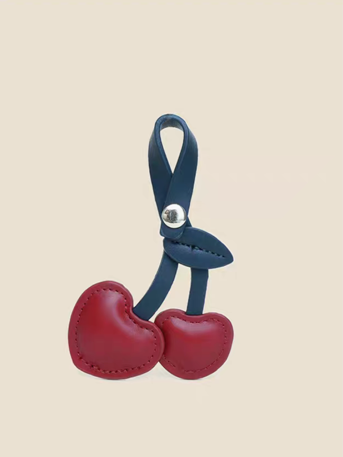 Red cherry heart PU leather keychain front view with stitched heart design and blue strap