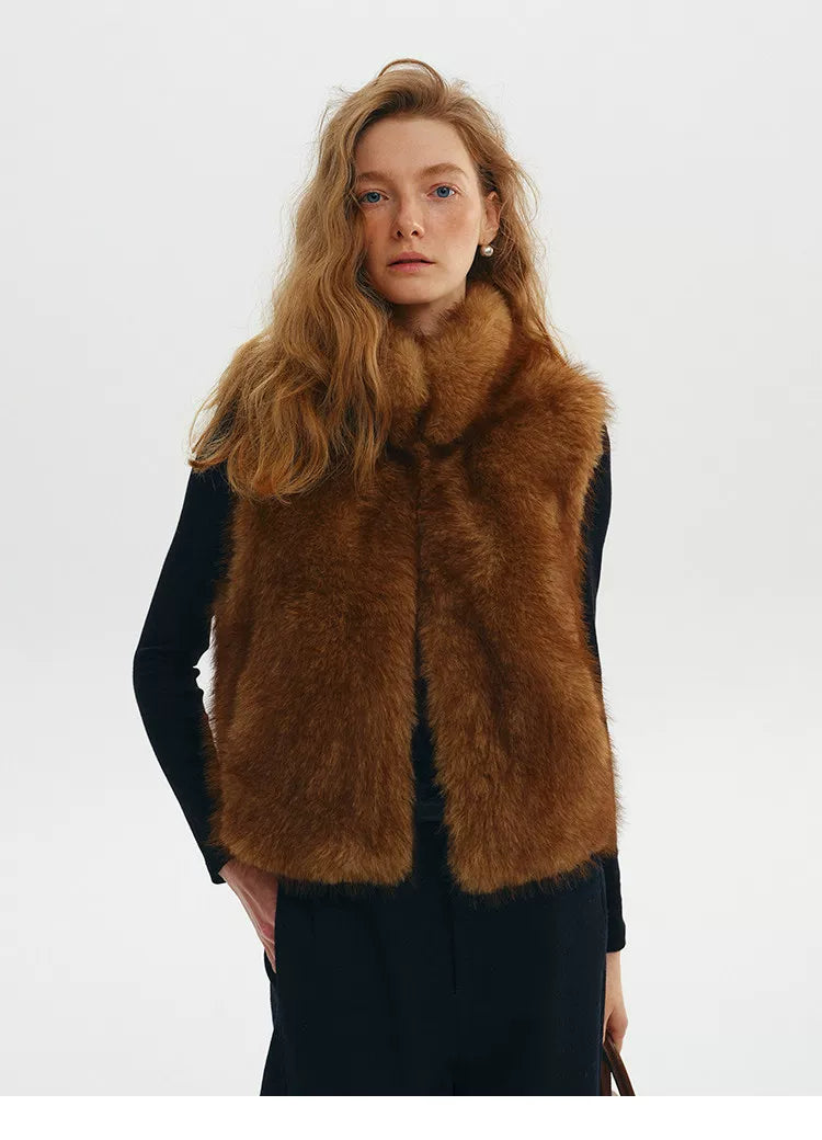 Chestnut cropped faux fur vest with stand collar and open front, worn over a black turtleneck