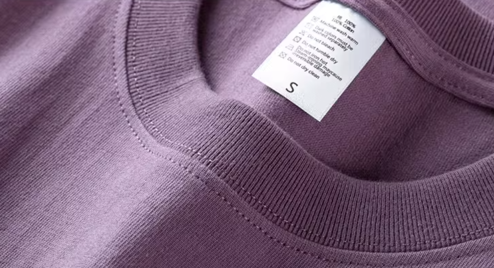 Chic Pocket Tee purple crewneck collar close-up showing stitching and inner label detail