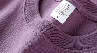 Chic Pocket Tee purple crewneck collar close-up showing stitching and inner label detail