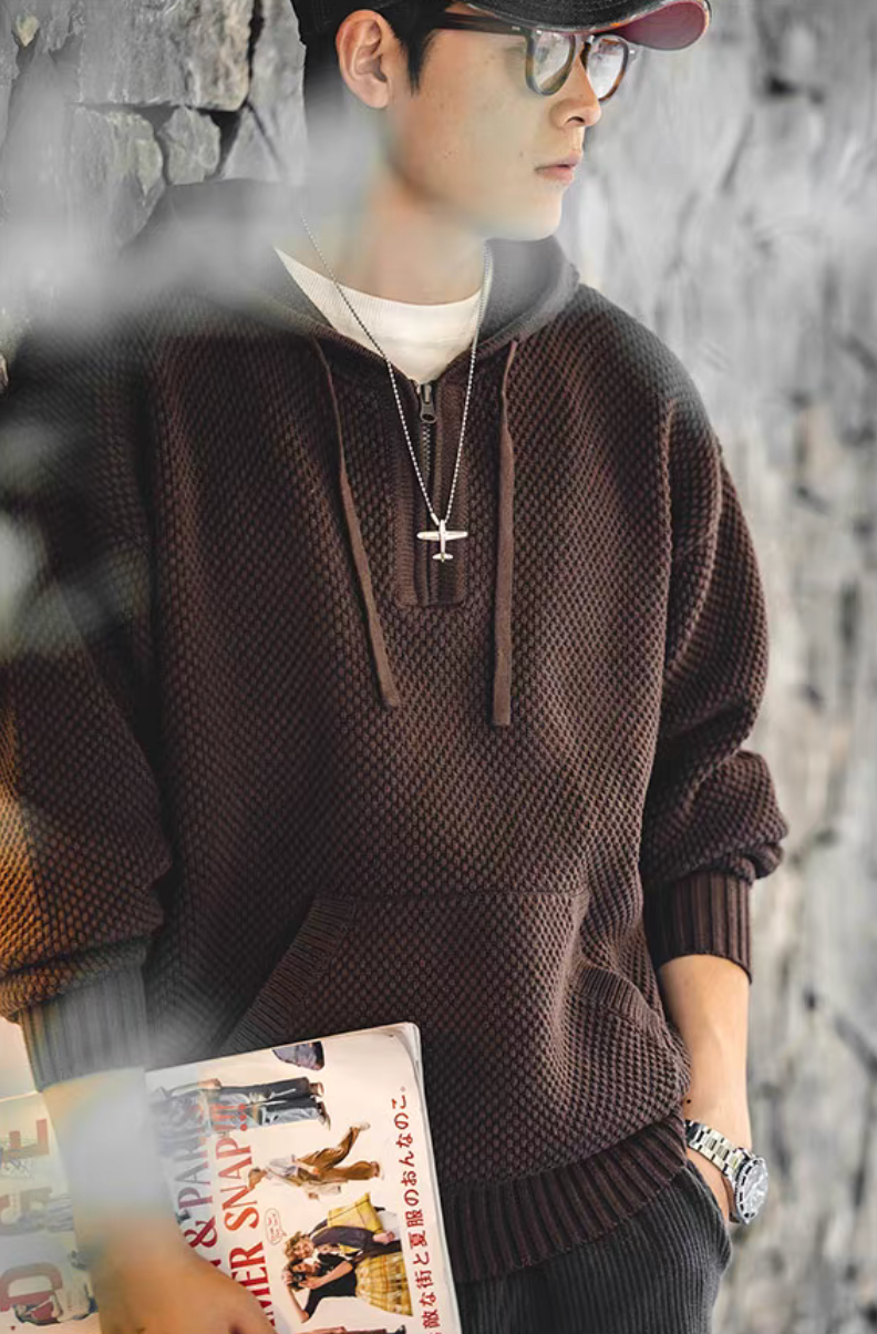 Chunky Waffle Knit Pullover Hoodie coffee styled in casual outfit holding magazine highlighting textured knit and relaxed silhouette