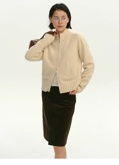 Woman wearing cream wool zip-up cardigan, full front view with mock neck and double zipper