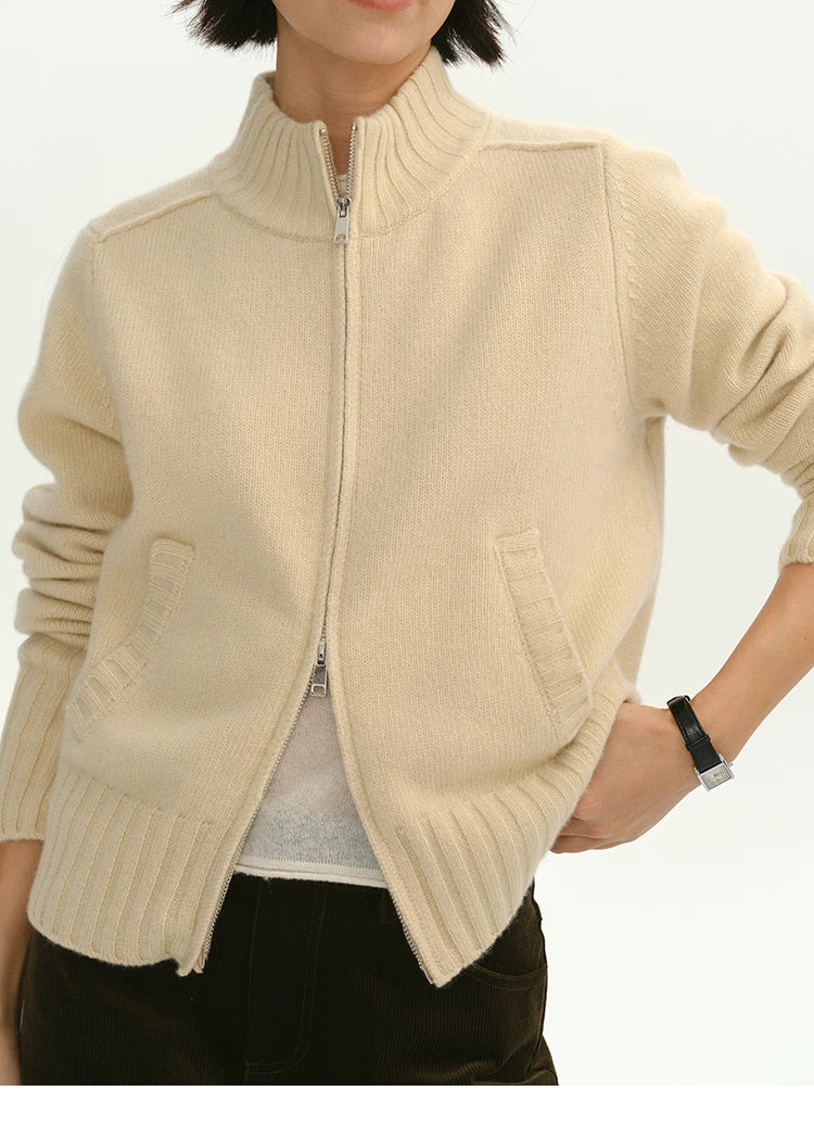 Close-up view of cream wool zip-up cardigan showing ribbed mock neck and double zipper