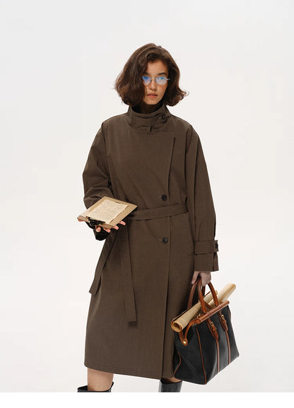 Coffee brown stand-collar city trench coat shown in full front view with bag and notebook.