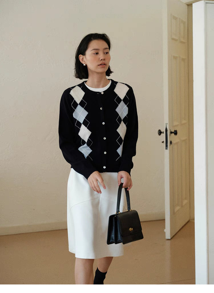 Classic Argyle Wool Button Cardigan in navy blue, front view on model with white skirt and Ivy League styling