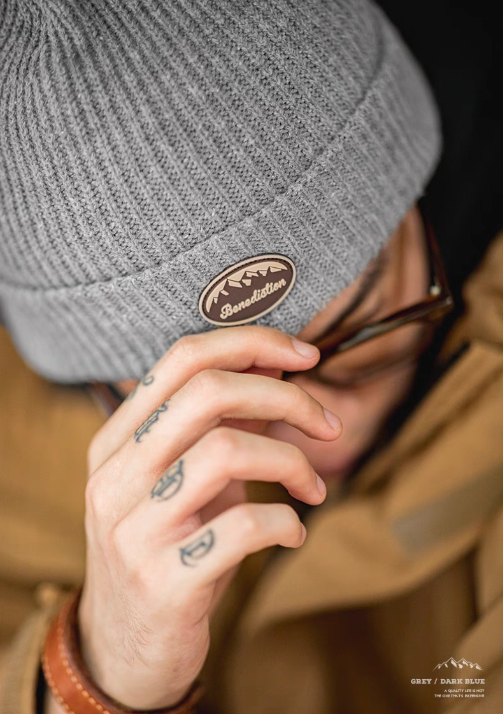 Top close-up view of Classic Ribbed Knit Beanie with Logo Detail in gray highlighting folded brim and embossed logo patch