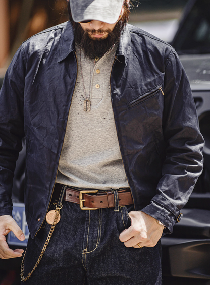 Man wearing Dark Blue Classic Trail Waxed Jacket front view styled with jeans and belt for a rugged outdoor look