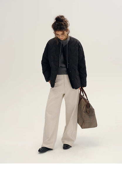 Model wearing black cloud-light quilted down jacket with wide-leg cream pants and tote bag.