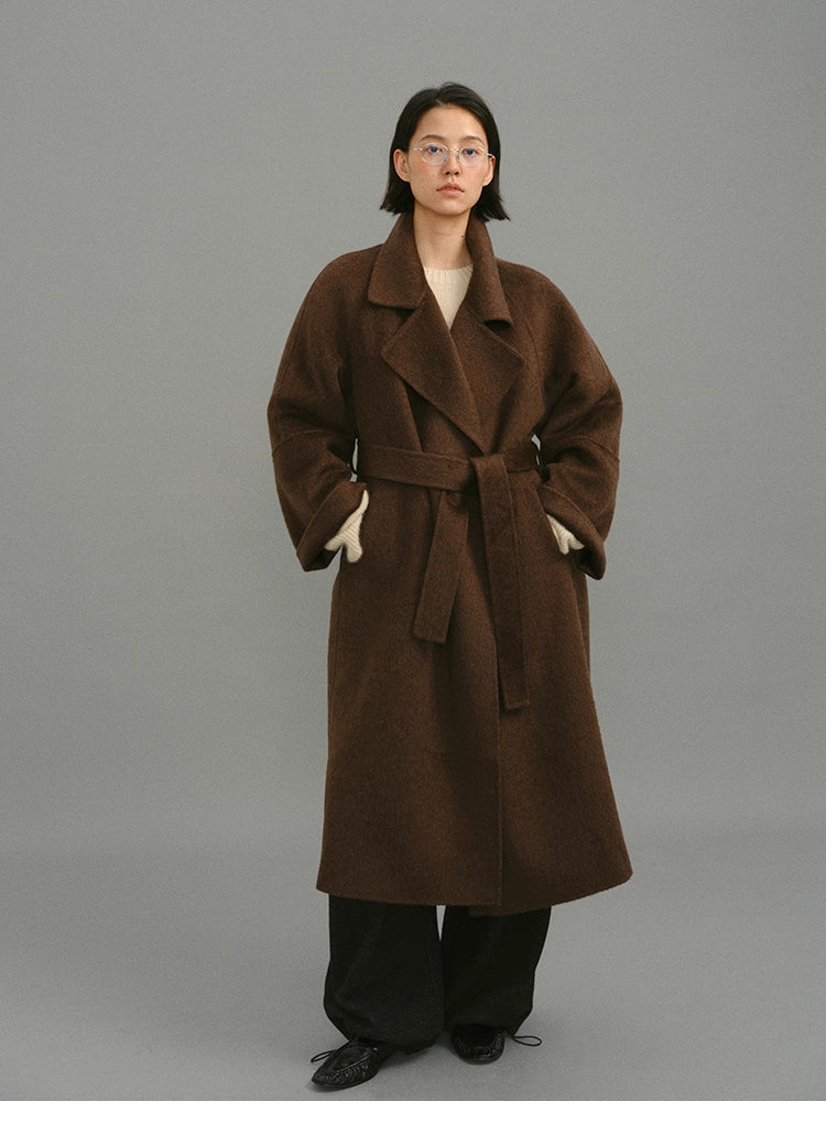 Full-length front view of dark coffee oversized wrap coat with tie belt.