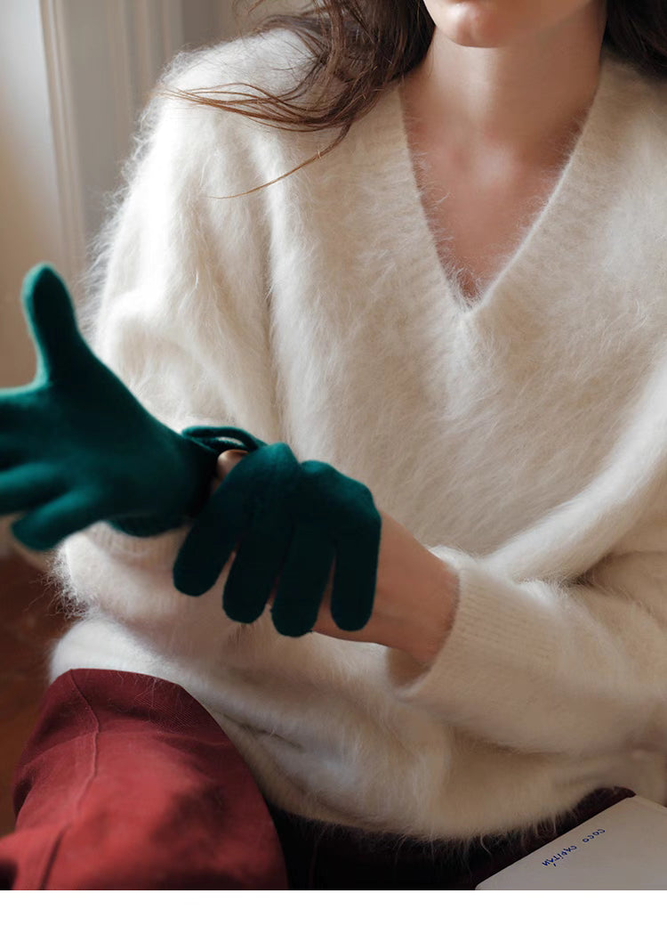 Cloud white brushed wool sweater detail adjusting gloves highlighting fine knit texture and V neck design
