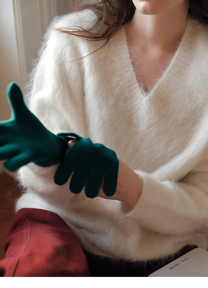 Cloud white brushed wool sweater detail adjusting gloves highlighting fine knit texture and V neck design