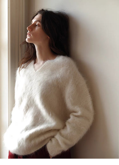 Cloud white brushed wool sweater side profile near window highlighting soft fluffy texture and wide sleeves