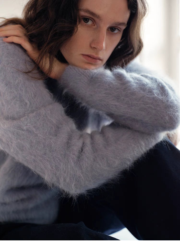 Misty blue brushed wool sweater close up showing soft fuzzy fibers and cozy texture detail