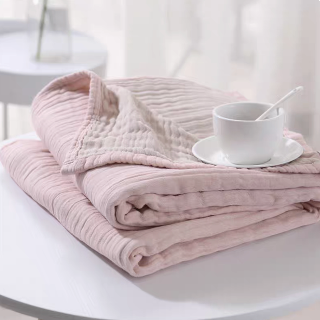 CloudSoft Four-Layer Gauze Cotton Blanket in Pink Camel folded on table showing soft four-layer gauze cotton texture