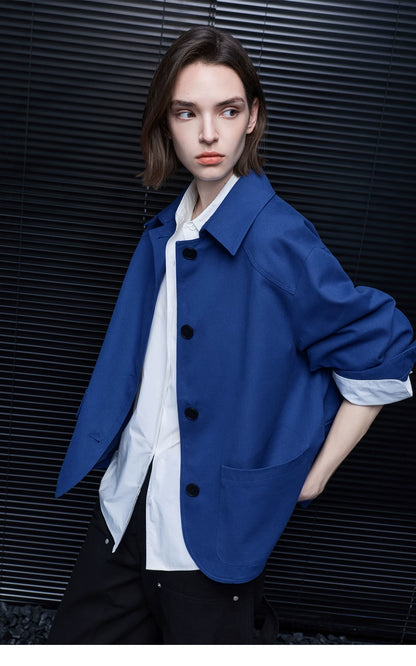 Three-quarter view of a Cobalt Blue cotton chore jacket with point collar and rounded front hem