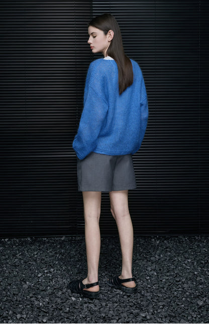 Back view of Cobalt Blue fuzzy knit sweater with dropped shoulders, styled with grey shorts and black sandals