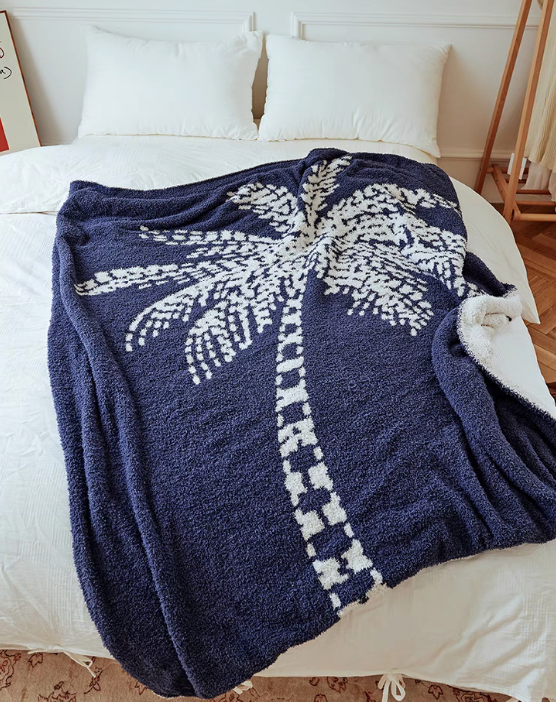 Blue coconut tree throw blanket placed on bed adding cozy and modern home decor style