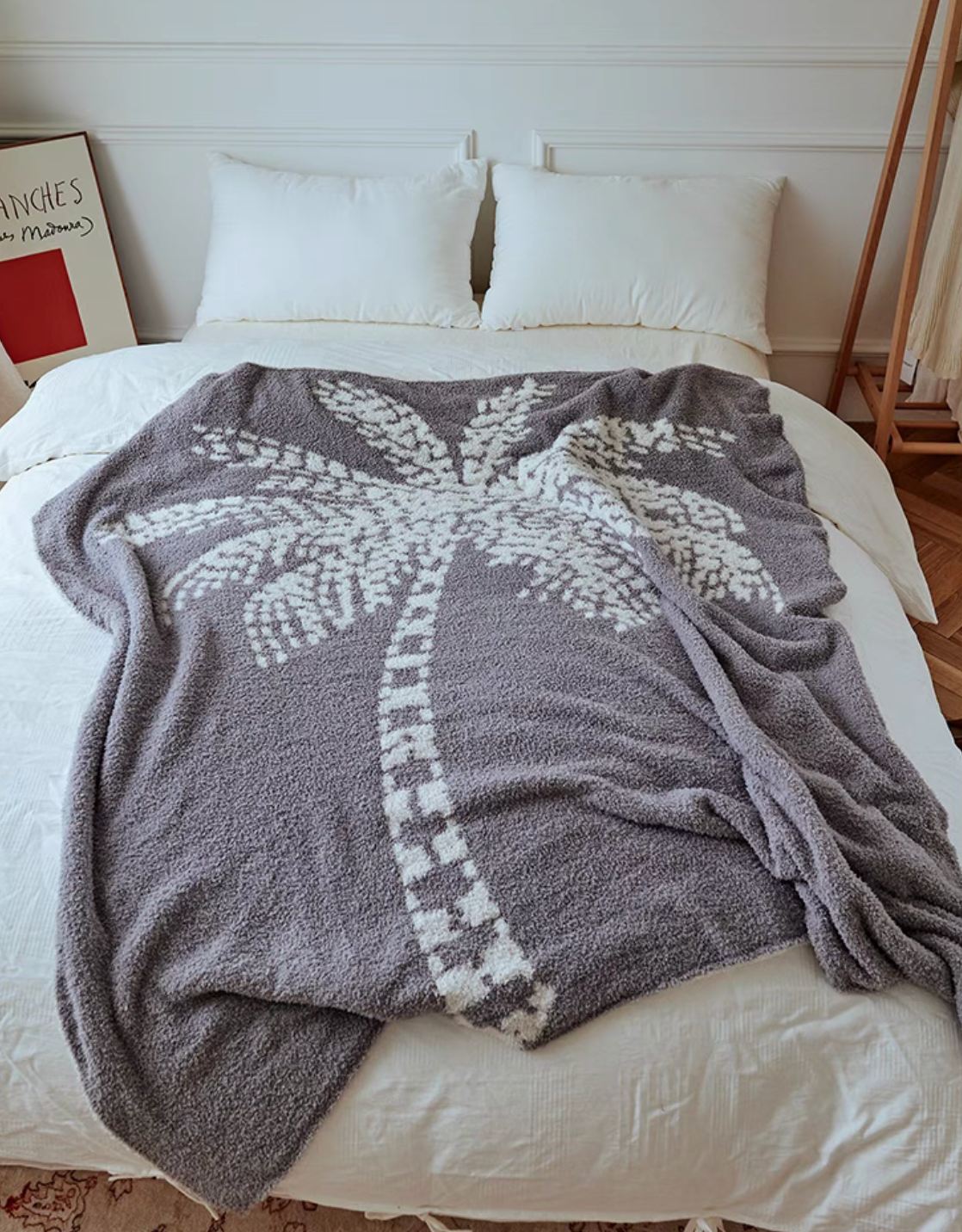 Gray coconut tree throw blanket spread across bed creating warm and inviting bedroom atmosphere