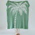 Green coconut tree jacquard throw blanket fully displayed with large white palm tree design