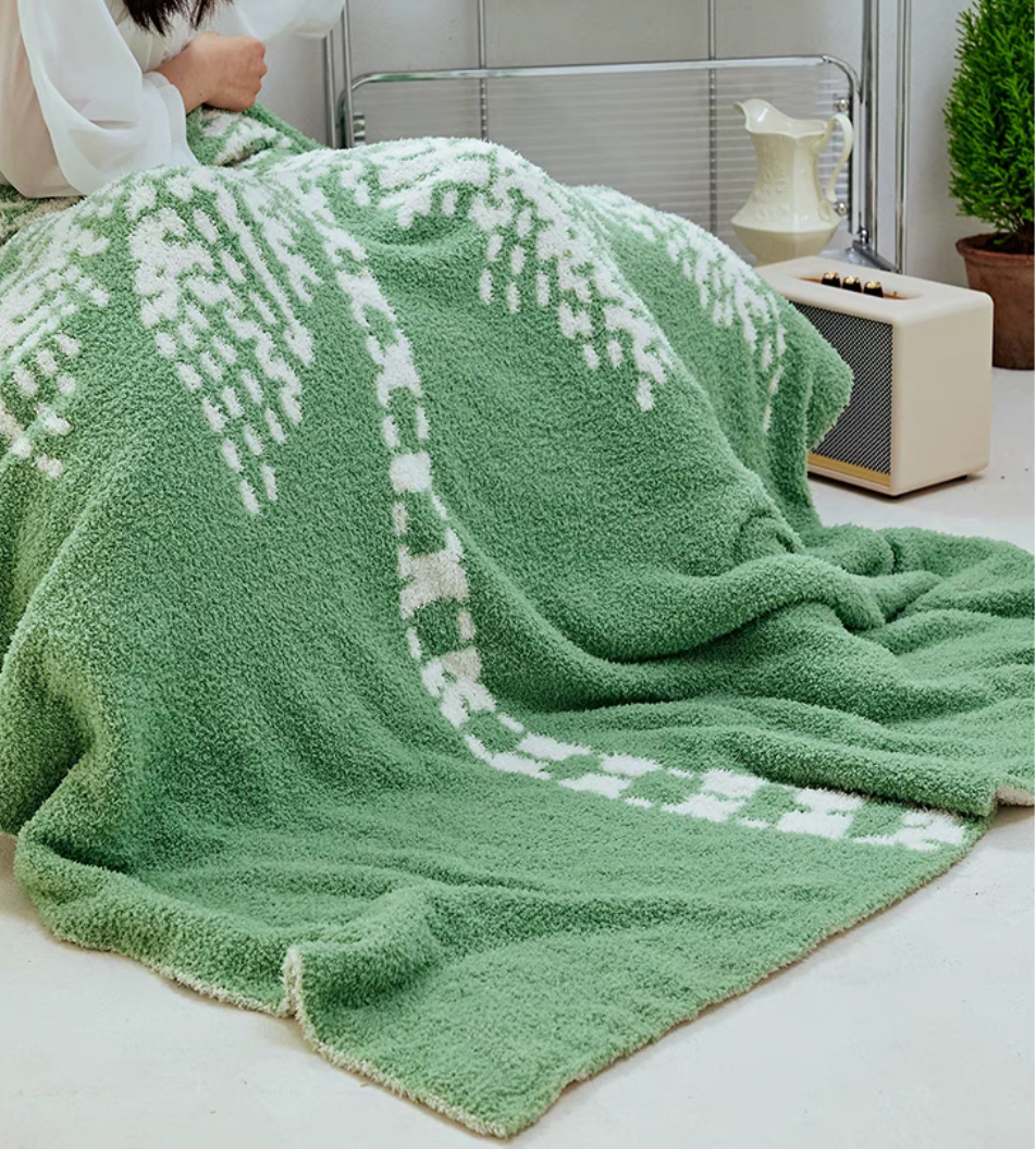 Green coconut tree throw blanket draped over person sitting, showing cozy soft fabric in home setting