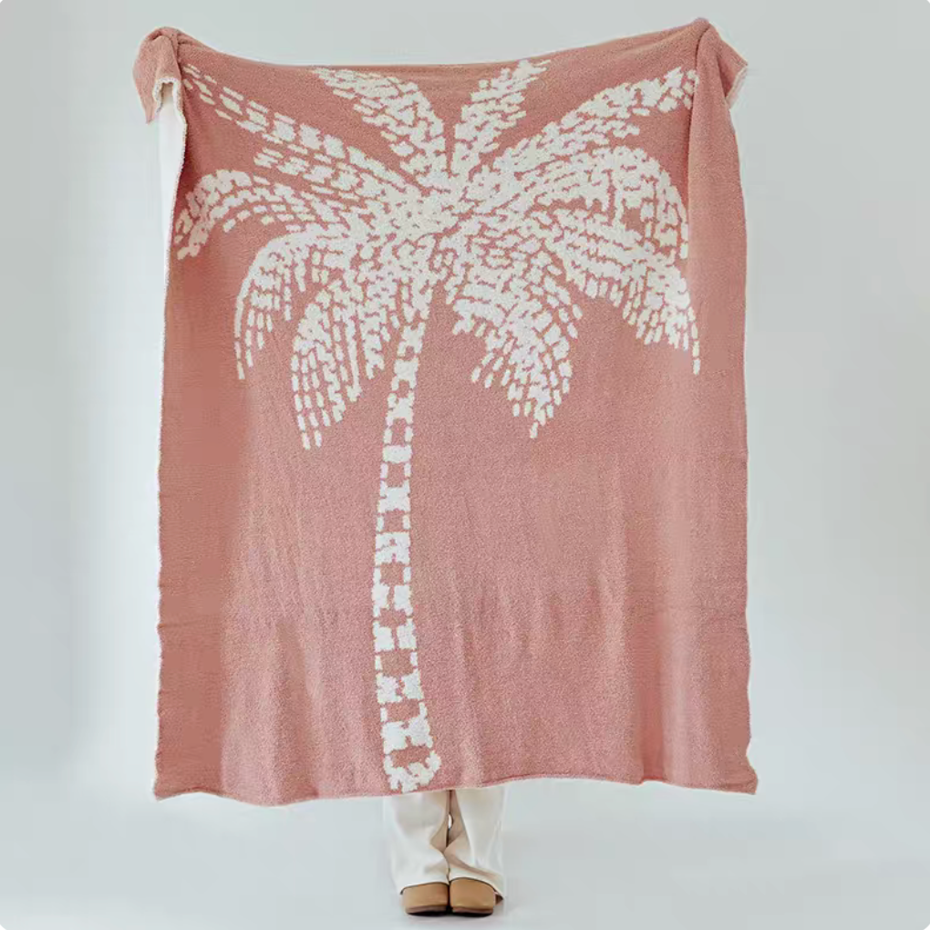 Pink coconut tree jacquard throw blanket fully displayed with large white palm tree pattern