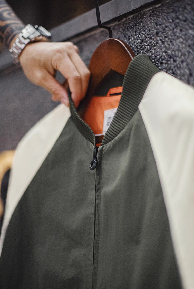 Close-up of ribbed collar and orange inner lining on MA-1 bomber