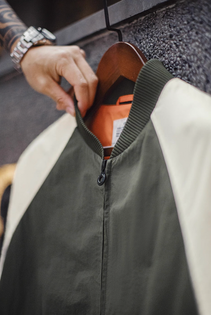 Close-up of ribbed collar and orange inner lining on MA-1 bomber