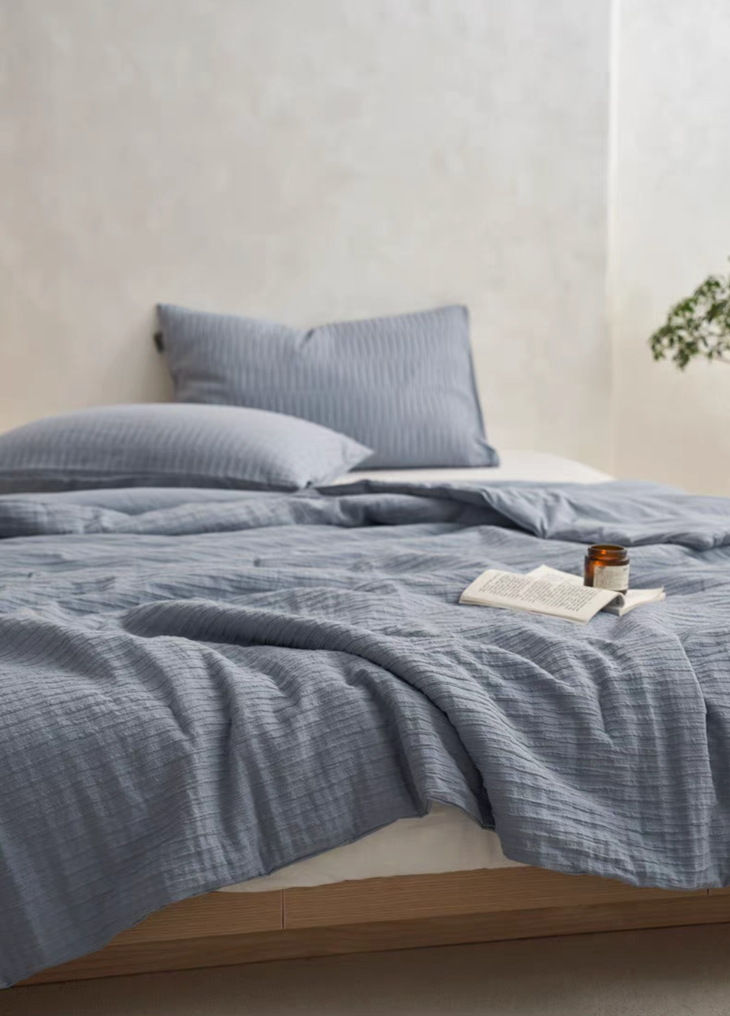 Navy Blue Colorful cotton comforter and sham set styled on bed with matching pillow shams in minimalist room