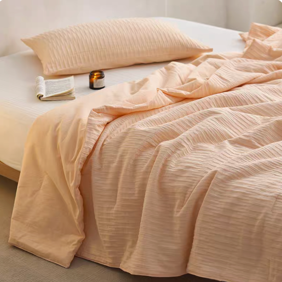 Orange Colorful cotton comforter and sham set draped across bed with matching pillow sham and jacquard wave texture