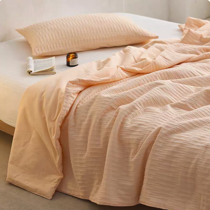 Orange Colorful cotton comforter and sham set draped across bed with matching pillow sham and jacquard wave texture
